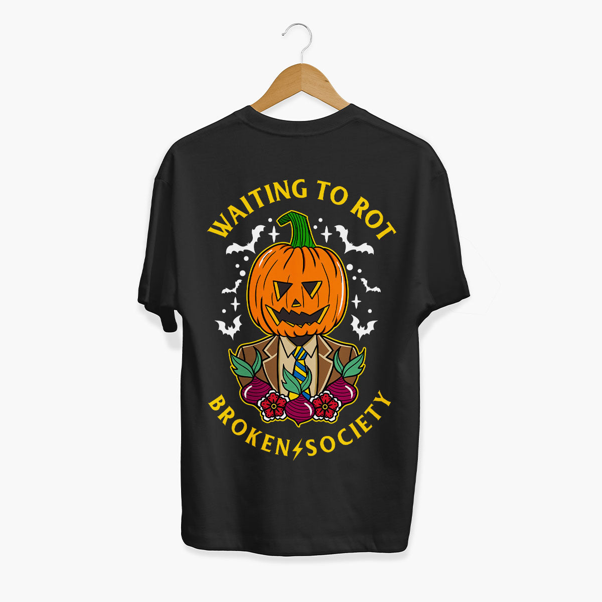 A black short-sleeve t-shirt hanging on a wooden hanger against a light gray background. The back of the shirt features a colorful graphic of a jack-o'-lantern pumpkin wearing a suit, surrounded by bats, berries, and the text 'WAITING TO ROT' and 'BROKEN+SOCIETY' in yellow.
